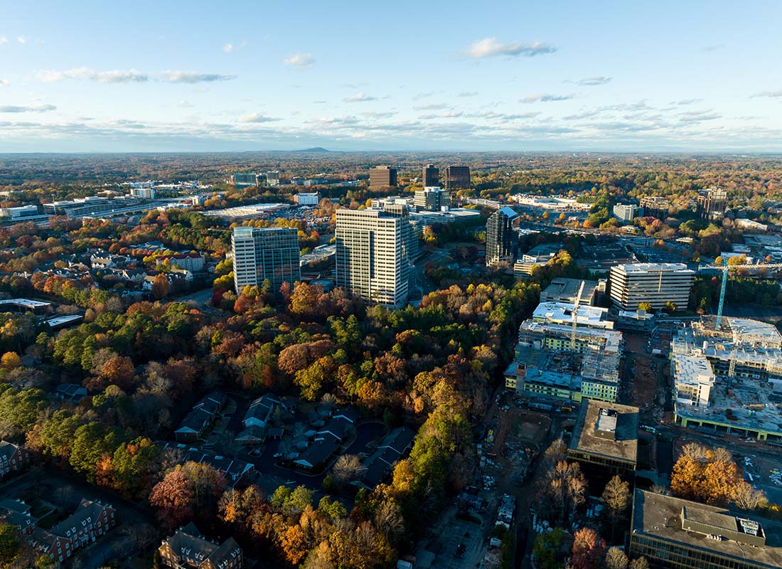 Roswell, GA - Aerial View of Commercial Buildings Surrounded by Colorful Fall Foliage in Roswell Georgia