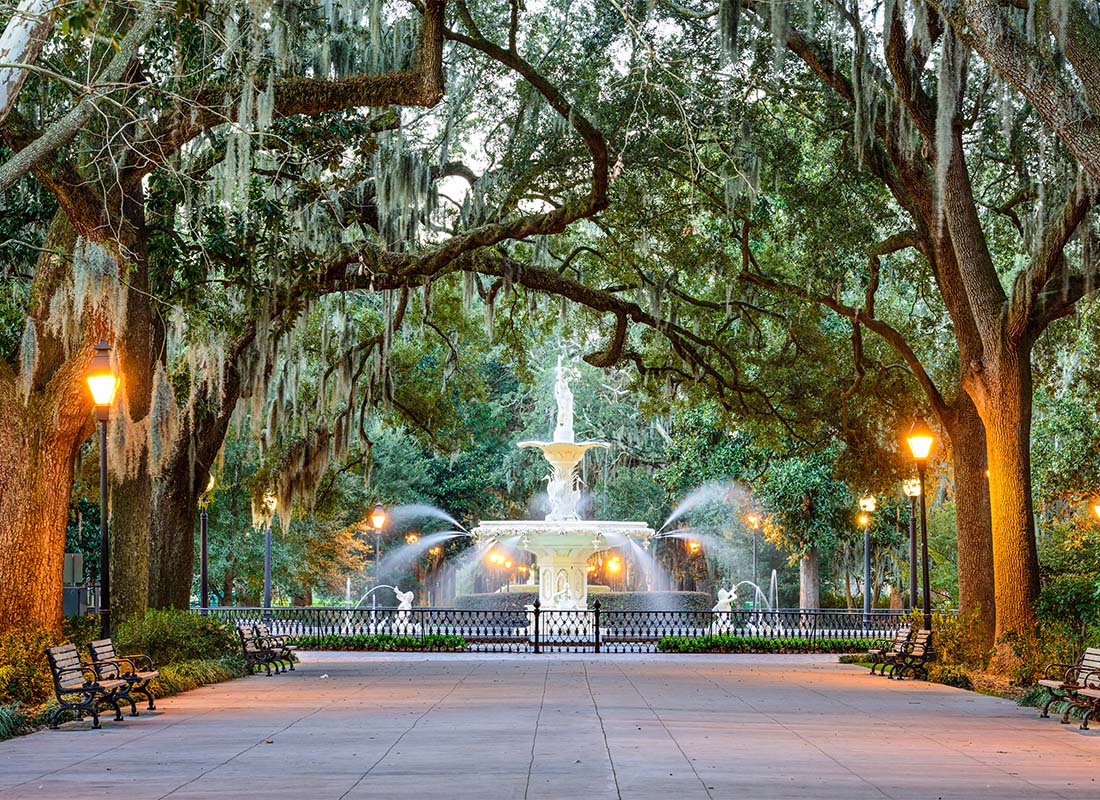 Service Center - Beautiful Fountain Surrounded by Southern Oak Trees in Savannah Georgia in a Park During the Evening
